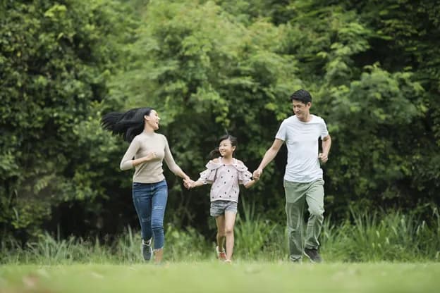 A person enjoying a leisurely walk outdoors in a park, illustrating the benefits of light exercise for health.